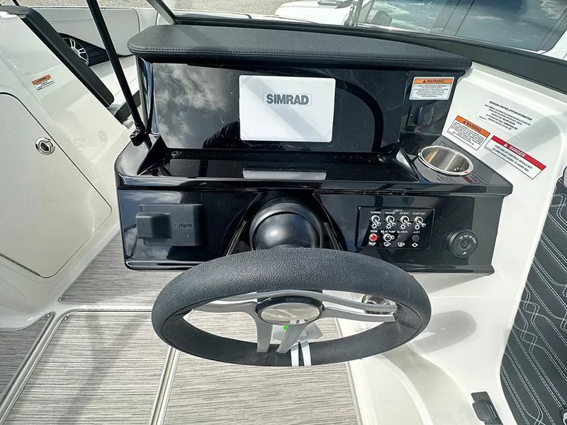 Slide: The Image of 2025 Sea Ray SPO 210 dashboard with Simrad display and steering wheel. - 5