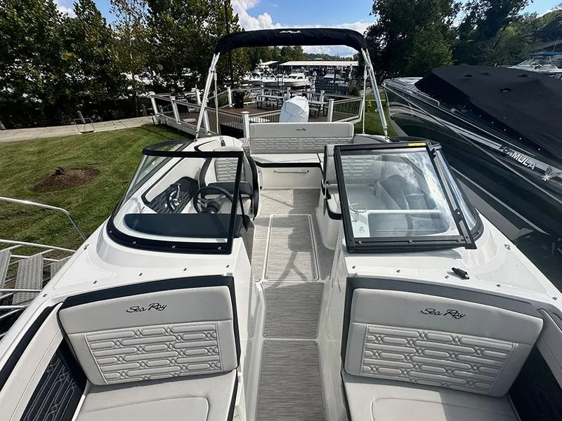 Slide: The Image of 2025 Sea Ray SPO 210 boat with sleek design and spacious seating at a marina. - 8