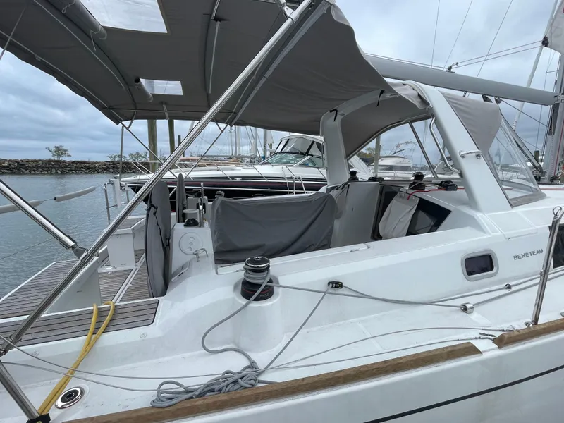 Slide: The Image of 2022 Beneteau Oceanis 38.1 sailboat with covered cockpit, docked in a marina. - 14