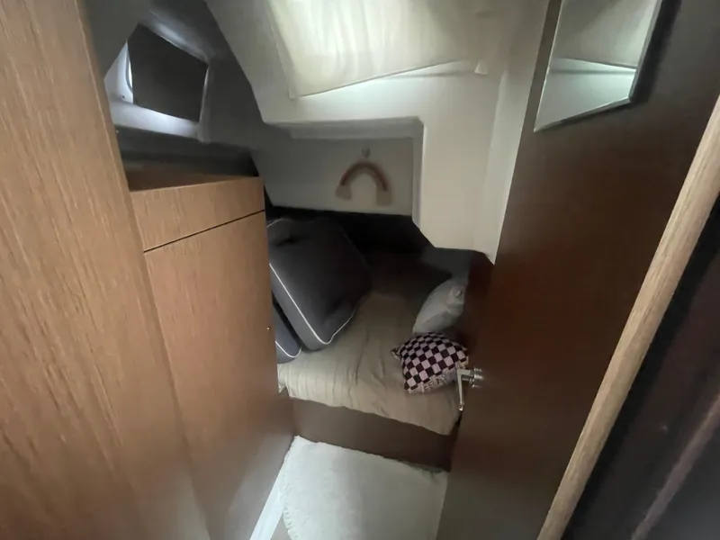 Slide: The Image of Cozy cabin interior of 2022 Beneteau Oceanis 38.1 sailboat with bed and storage. - 16