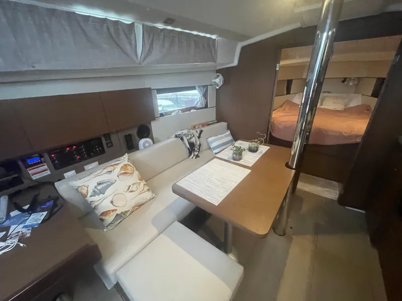 Slide: The Image of Interior of 2022 Beneteau Oceanis 38.1 yacht, featuring cozy seating and elegant design. - 18