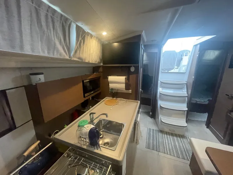 Slide: The Image of Modern kitchen interior of 2022 Beneteau Oceanis 38.1 yacht, featuring sink and appliances. - 19
