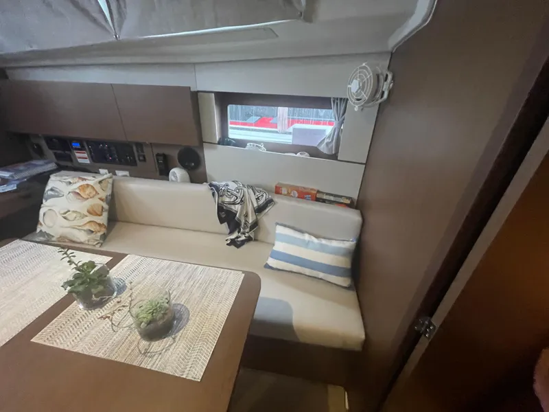 Slide: The Image of Interior of 2022 Beneteau Oceanis 38.1 yacht with cozy seating and decor. - 20