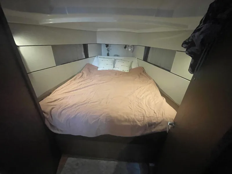 Slide: The Image of Cozy bedroom interior of 2022 Beneteau Oceanis 38.1 yacht with a neatly made bed. - 21