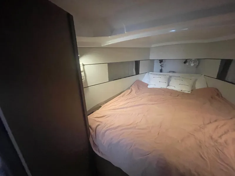 Slide: The Image of Cozy bedroom in 2022 Beneteau Oceanis 38.1 yacht with a neatly made bed. - 23