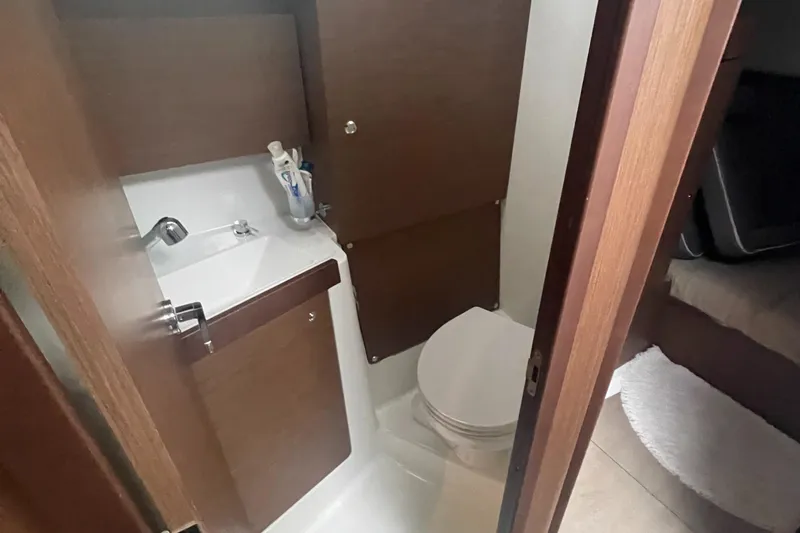 Slide: The Image of 2022 Beneteau Oceanis 38.1 bathroom with sink and toilet, compact and modern design. - 24
