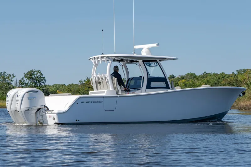 Slide: The Image of 2025 Sportsman Open 322 Center Console boat on calm water. - 10