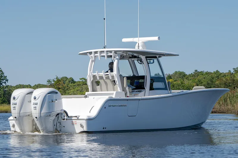 Slide: The Image of 2025 Sportsman Open 322 Center Console boat on calm water. - 11