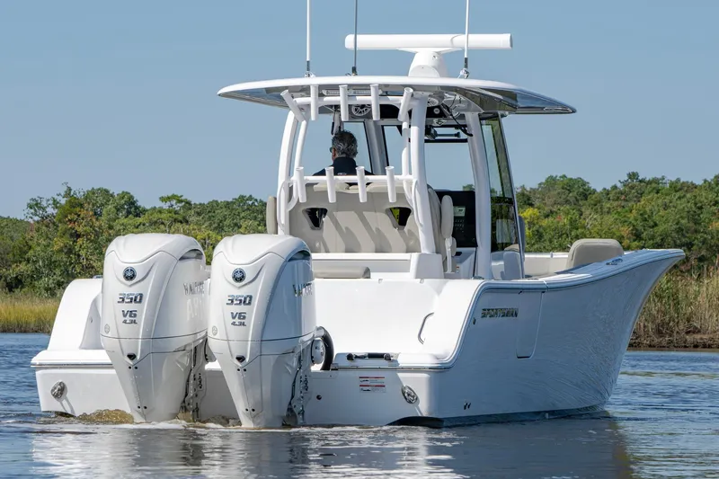 Slide: The Image of 2025 Sportsman Open 322 Center Console boat with twin engines on water. - 12