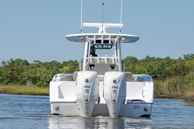 Slide: The Image of 2025 Sportsman Open 322 Center Console boat with twin engines on water. - 13