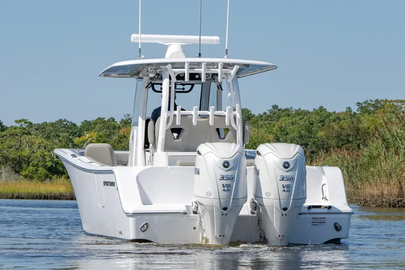 Slide: The Image of 2025 Sportsman Open 322 Center Console boat with dual engines on water. - 14