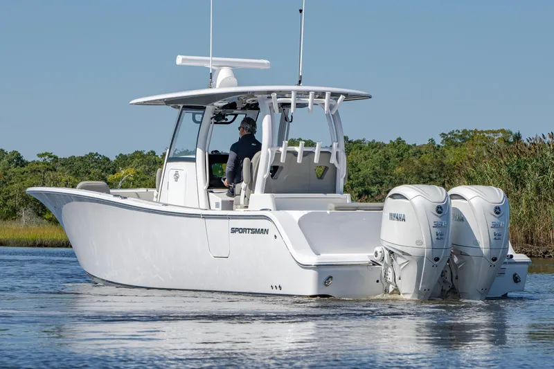 Slide: The Image of 2025 Sportsman Open 322 Center Console boat on water, featuring dual Yamaha engines. - 15