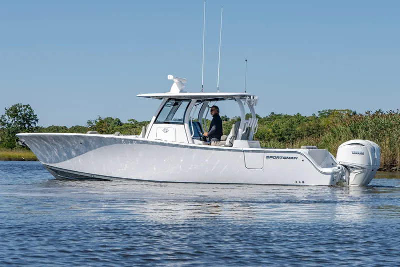 Slide: The Image of 2025 Sportsman Open 322 Center Console boat cruising on calm water. - 17
