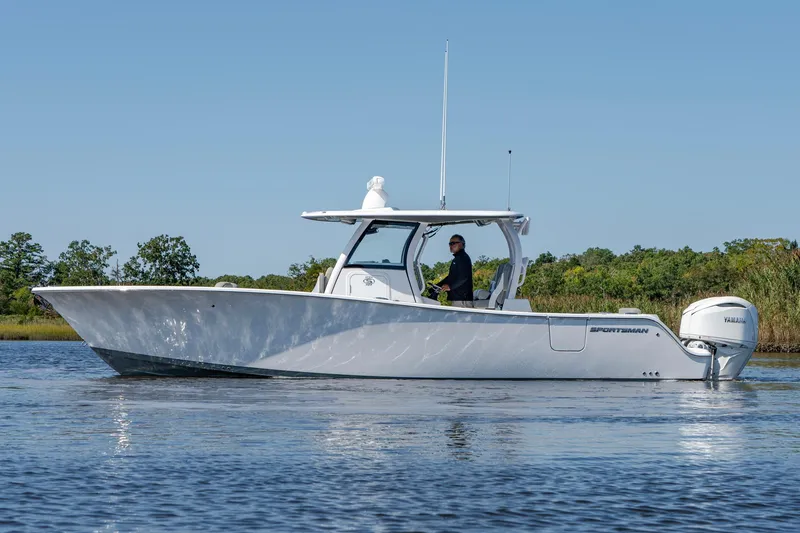 Slide: The Image of 2025 Sportsman Open 322 Center Console boat on calm water, side view. - 18