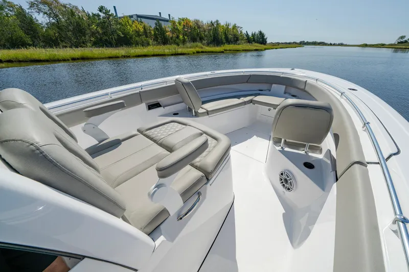 Slide: The Image of 2025 Sportsman Open 322 Center Console boat interior on a serene waterway. - 19