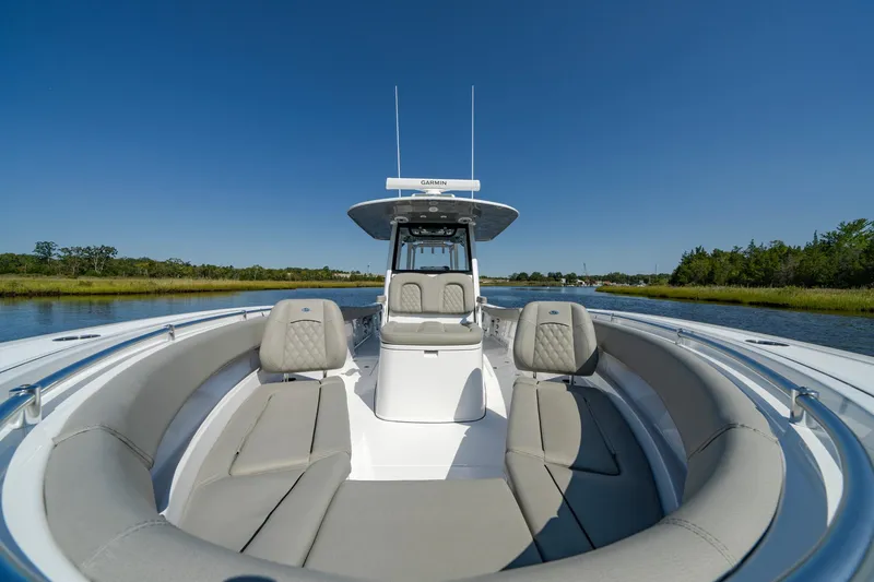 Slide: The Image of 2025 Sportsman Open 322 Center Console boat on calm water, featuring spacious seating. - 22