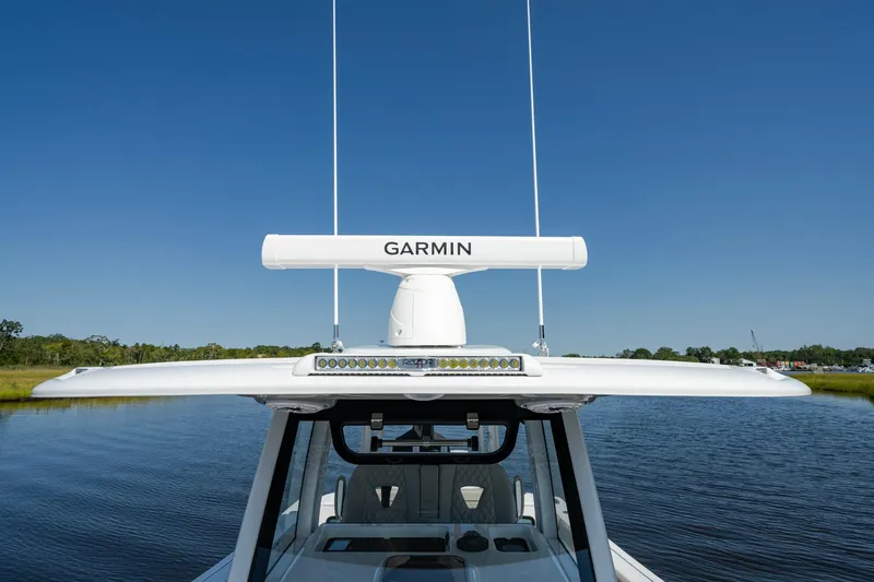 Slide: The Image of 2025 Sportsman Open 322 Center Console with Garmin radar on calm water. - 24