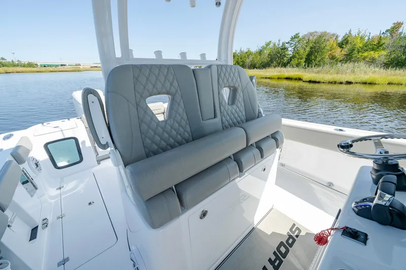 Slide: The Image of 2025 Sportsman Open 322 Center Console boat interior with plush seating by the water. - 27