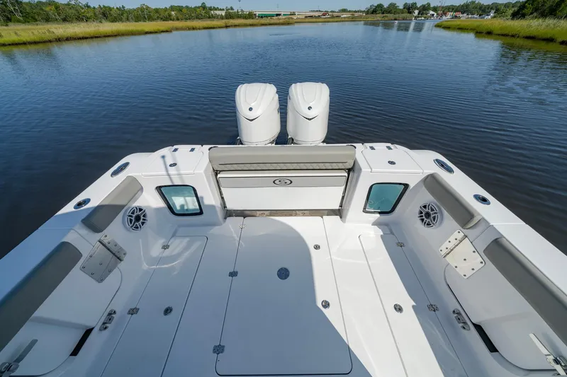 Slide: The Image of 2025 Sportsman Open 322 Center Console boat on calm water, rear view. - 29
