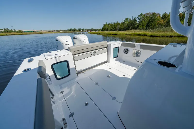 Slide: The Image of 2025 Sportsman Open 322 Center Console boat on calm water, showcasing spacious deck. - 30