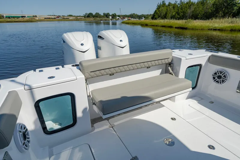 Slide: The Image of 2025 Sportsman Open 322 Center Console boat with dual engines on a calm lake. - 32