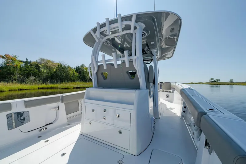 Slide: The Image of 2025 Sportsman Open 322 Center Console boat on calm water, featuring sleek design and spacious deck. - 33
