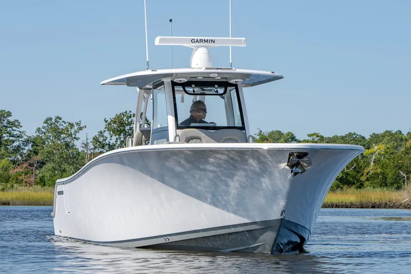 Slide: The Image of 2025 Sportsman Open 322 Center Console boat on calm water. - 5