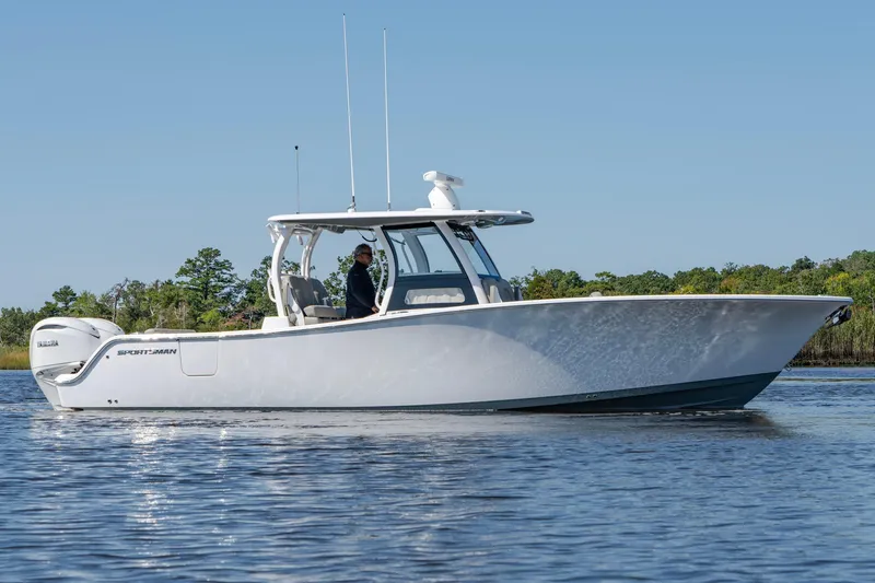 Slide: The Image of 2025 Sportsman Open 322 Center Console boat on calm water. - 8