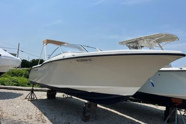 Slide: The Image of 2020 Key West 239 DFS boat on display, parked on gravel under a clear sky. - 0