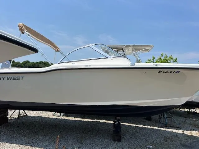 Slide: The Image of 2020 Key West 239 DFS boat on display, white hull, blue sky background. - 1