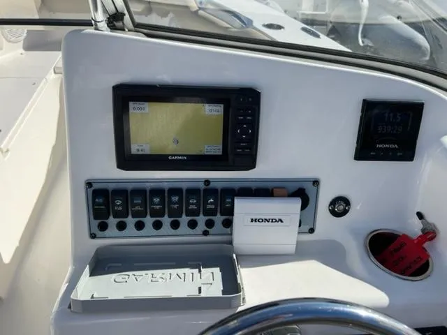 Slide: The Image of Key West 239 DFS 2020 boat dashboard with Garmin GPS and Honda controls. - 11