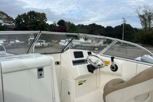 Slide: The Image of 2020 Key West 239 DFS boat interior with steering wheel and dashboard controls. - 12
