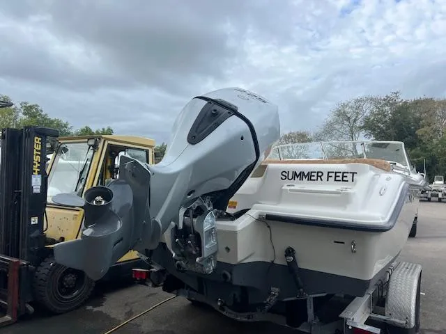 Slide: The Image of 2020 Key West 239 DFS boat named "Summer Feet" on trailer, overcast sky. - 14