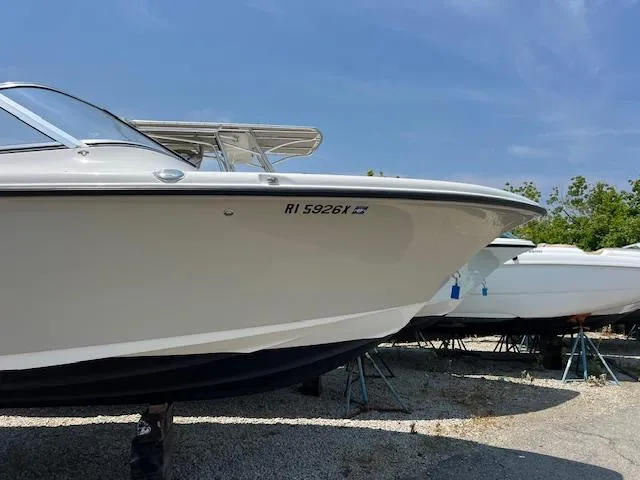 Slide: The Image of 2020 Key West 239 DFS boat on stands under clear blue sky. - 2
