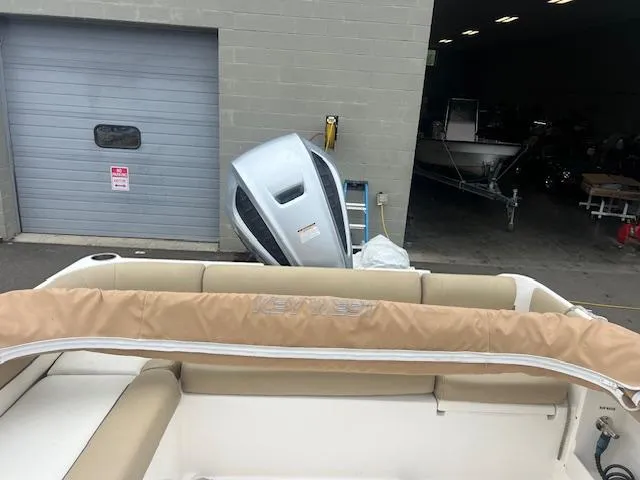 Slide: The Image of 2020 Key West 239 DFS boat with outboard motor near a garage. - 4