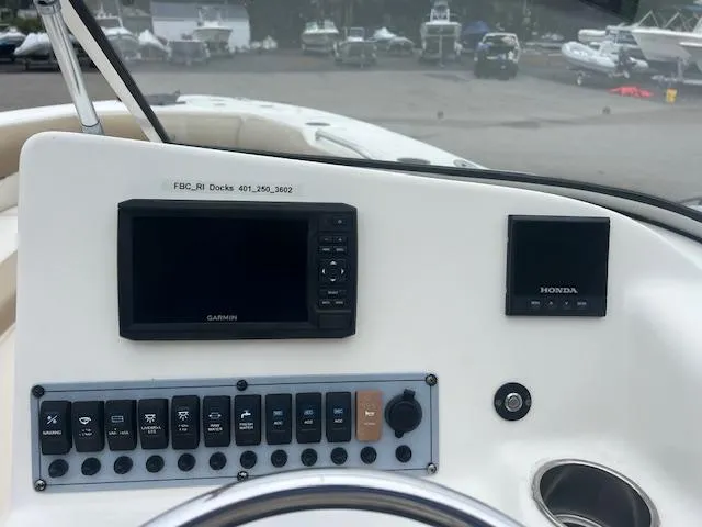 Slide: The Image of Key West 239 DFS 2020 dashboard with Garmin and Honda displays at marina. - 8