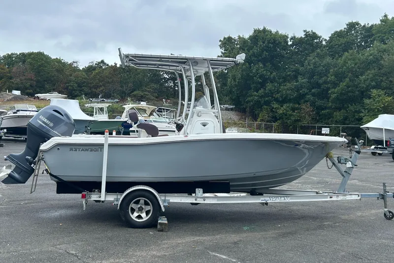 Slide: The Image of 2017 Tidewater 198 CC Adventure boat on trailer, parked outdoors. - 0