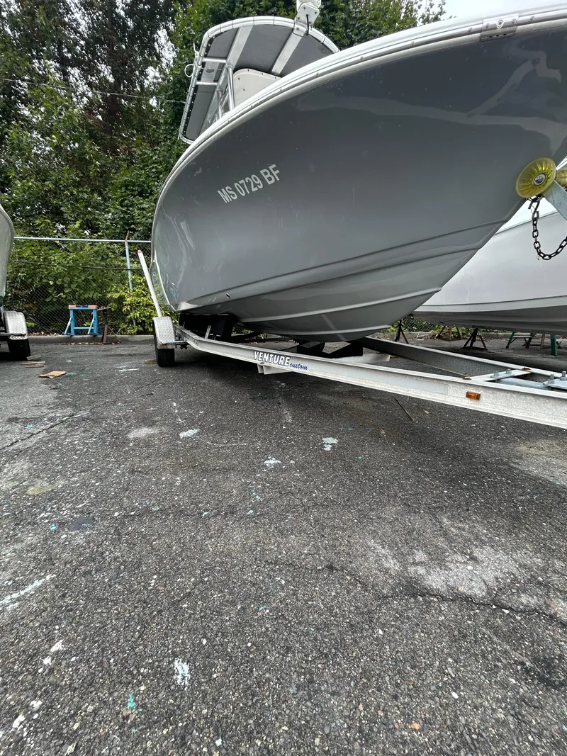 Slide: The Image of 2017 Tidewater 198 CC Adventure boat on trailer in outdoor setting. - 10
