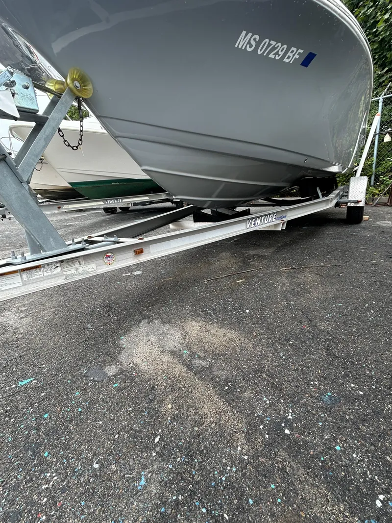 Slide: The Image of 2017 Tidewater 198 CC Adventure boat on trailer, parked on asphalt. - 19