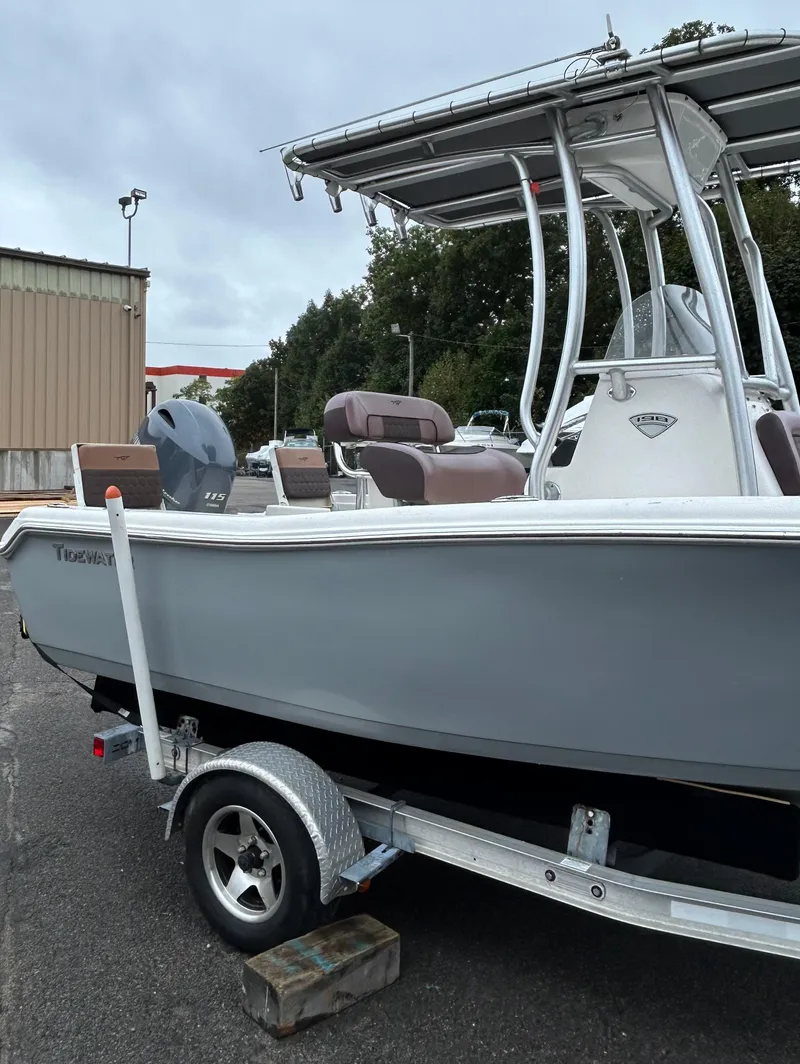 Slide: The Image of 2017 Tidewater 198 CC Adventure boat on trailer, gray hull, outdoor setting. - 5