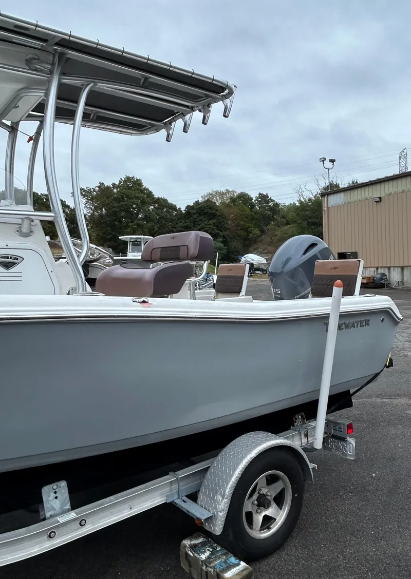 Slide: The Image of 2017 Tidewater 198 CC Adventure boat on trailer, parked outdoors. - 6