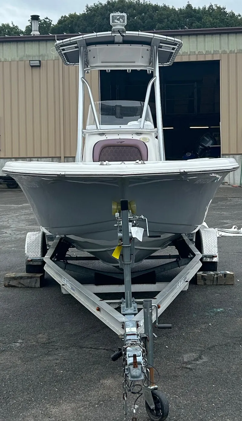 Slide: The Image of 2017 Tidewater 198 CC Adventure boat on trailer, parked outside a warehouse. - 8