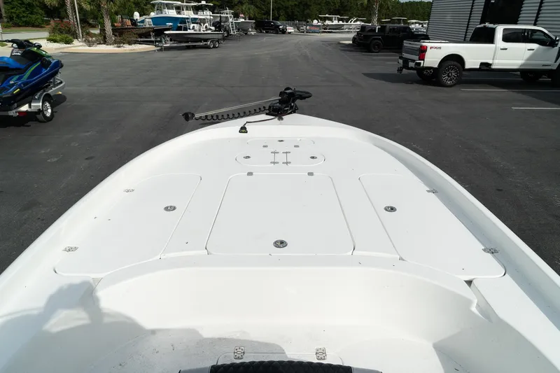 Slide: The Image of 2025 Turner Boatworks 2500 VS, white deck view, parked in a marina lot. - 12