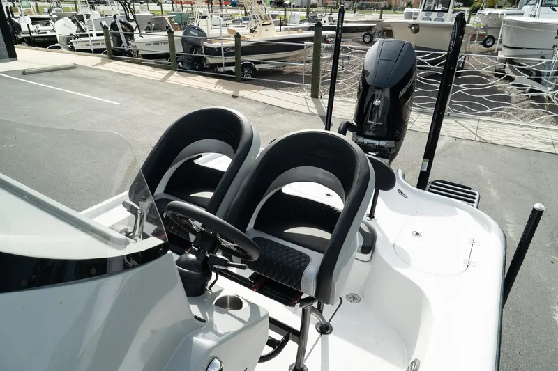 Slide: The Image of 2025 Turner Boatworks 2500 VS with dual seats and outboard motor at marina. - 13