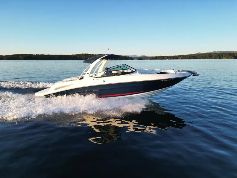 Slide: The Image of 2015 Sea Ray 300 SLX speedboat cruising on a calm lake. - 10