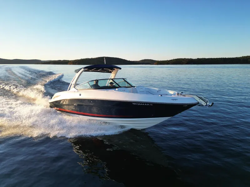 Slide: The Image of 2015 Sea Ray 300 SLX speedboat cruising on a serene lake at sunset. - 11