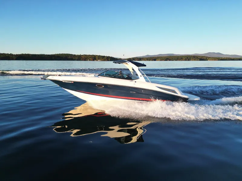 Slide: The Image of 2015 Sea Ray 300 SLX cruising on a serene lake at sunset. - 14