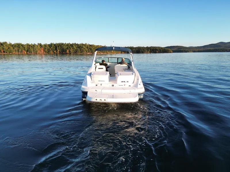 Slide: The Image of 2015 Sea Ray 300 SLX boat cruising on a serene lake. - 16