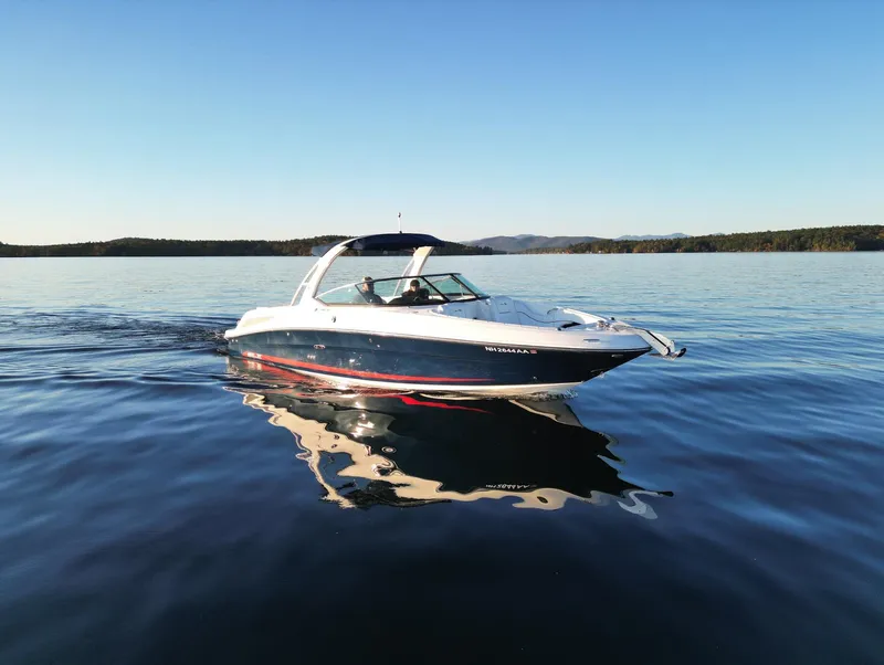Slide: The Image of 2015 Sea Ray 300 SLX cruising on a calm lake under clear blue skies. - 17