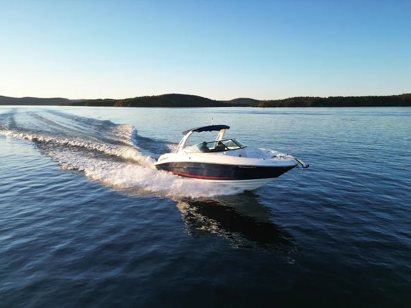 Slide: The Image of 2015 Sea Ray 300 SLX cruising on a serene lake at sunset. - 19